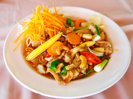 Stir-fried pork with cashew nuts, mixed seasonal vegetables and dried chilli pepper. Delicious thai food Moo Pad Med Ma-Muang Himmapanの写真素材