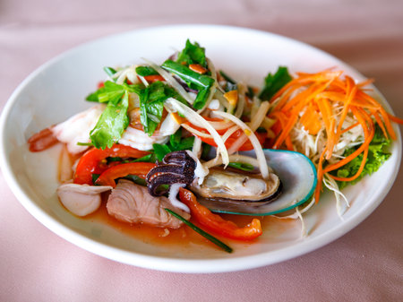 Thai sour spicy seafood salad with Shrimp, fish, octopus, squid and vegetables, Thai cuisine Yum Woon Sen, Yum talayの写真素材