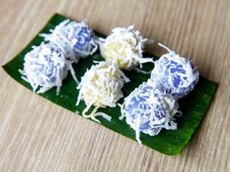 Khanom tom sweets are made by boiling balls of dough made from glutinous rice powder, coconut cream, grated coconut, sugar, and flavorings. They are covered with more grated coconut. Banana leafの写真素材