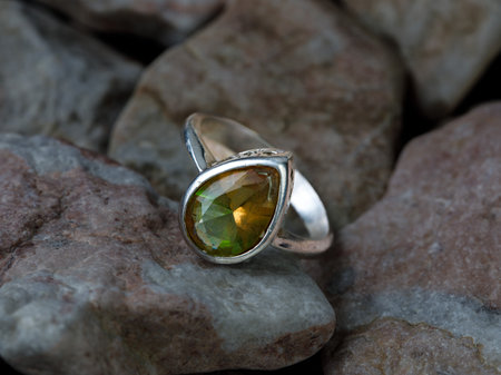 Fashion silver ring with turkish color changing Zultanite gem stone. natural diaspore. It changes its color from red purple to green in depend on lightの写真素材