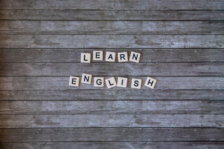 learn english word written on wooden background. learn english text on table, concept. Horizontalの写真素材
