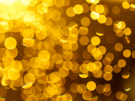 golden yellow abstract circular background with bokeh defocused blurred lightsの写真素材