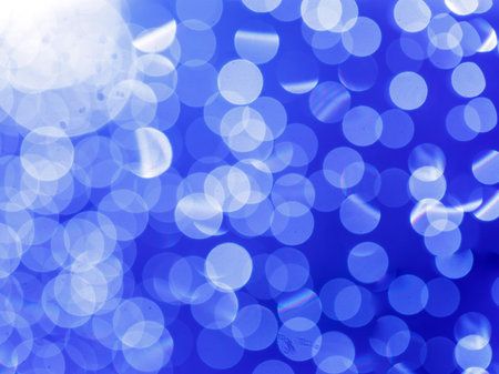 blue white abstract circular background with bokeh defocused blurred lightsの写真素材