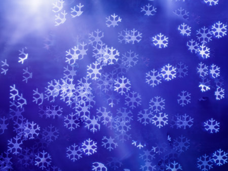 Abstract Christmas blue bokeh Snowflake shaped background, winter blurred backdrop.の写真素材