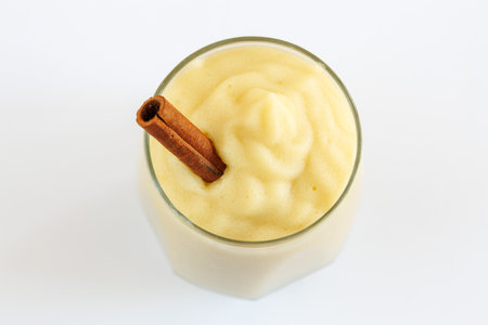 Fresh homemade applesauce, apple puree, mousse, sauce in glass with cinnamon isolated on white background, top view, close up. Organic vegetarian food. Healthy eatingの写真素材