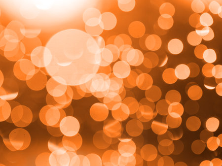 apricot crush abstract circular background with bokeh defocused blurred lights.の写真素材