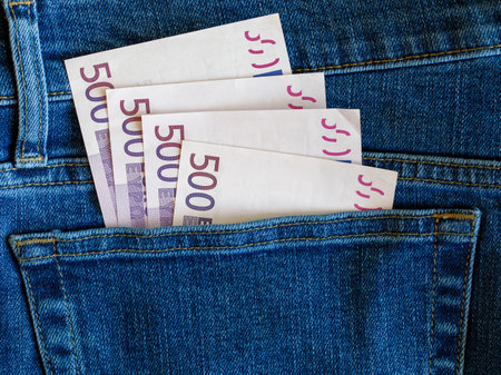 500 euro banknotes in blue jeans pocket top view with copy space. Money, business, finance, saving, banking, wealth, waste concept. Exchange Rates.の写真素材