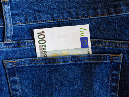 One 100 euro banknote in blue jeans pocket top view with copy space. Money, business, finance, saving, banking, wealth, waste concept. Exchange Rates.の写真素材