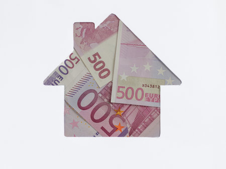 Euro banknote in shape of house on white background. Concept of Investment property, Mortgage concept. Investment risk and uncertainty in real estate housing market, utility bills. Top view flat lay.の写真素材