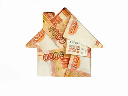 Ruble banknote in shape of house on white background. Concept of Investment property, Mortgage concept. Investment risk and uncertainty in real estate housing market, utility bills. Top view flat lay.の写真素材