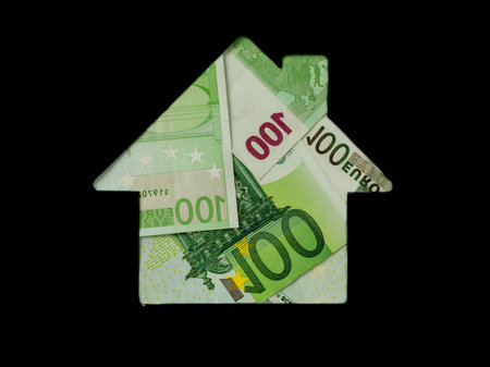 Euro banknote in shape of house on black background. Concept of Investment property, Mortgage concept. Investment risk and uncertainty in real estate housing market, utility bills. Top view flat lay.の写真素材
