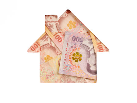 Thai bath banknote in shape of house on white background. Concept of Investment property, mortgage, Investment risk and uncertainty in real estate housing market, utility bills. Top view flat lay.の写真素材