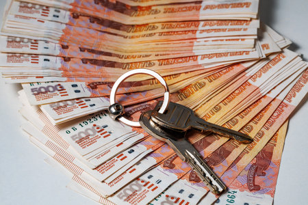 Key on stack of banknotes, many banknotes of five thousand Russian rubles as a background, packed stack of banknotes 5000 rubles, mortgage conceptの写真素材