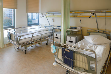 Recovery Room with beds and comfortable medical. Interior of an empty hospital room. Clean and empty room with two beds for child and mother in the new medical center.の写真素材