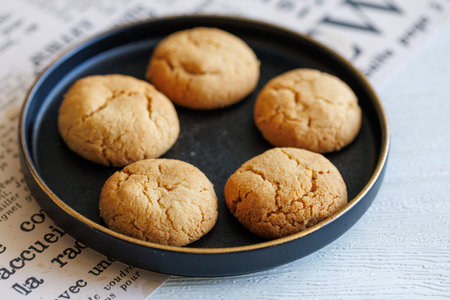 Quick Easy Vegan Tahini Cookies on black plate on white background.の写真素材