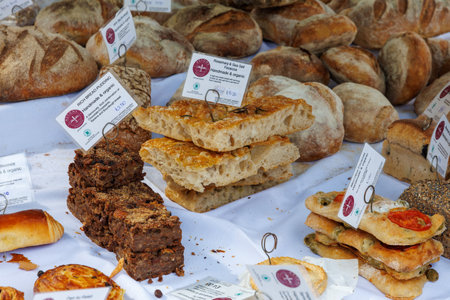 Pile of freshly baked wholemeal breads in the bakery or outdoor local farmer market.の写真素材
