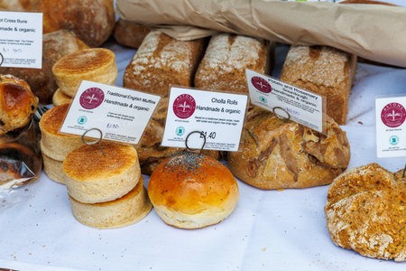 Pile of freshly baked wholemeal breads and buns in the bakery or local farmer market.の写真素材