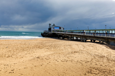 Empty beach and Bournemouth pier viewed from the West Beach in rainy day in spring.の写真素材
