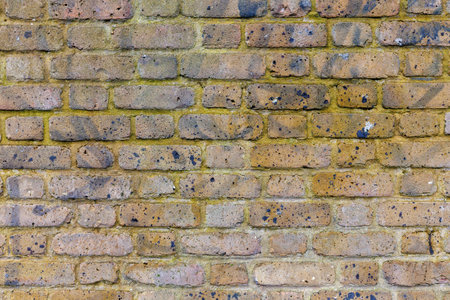 Beige grunge weathered brick wall, abstract full frame background texture with old dirty and vintage style patternの写真素材