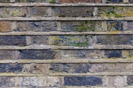 Beige brown grey grunge weathered brick wall, abstract full frame background texture with old dirty and vintage style pattern. Close upの写真素材