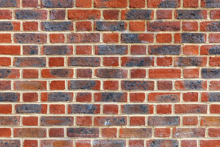 Red and black grunge weathered brick wall, abstract full frame background texture with old dirty and vintage style patternの写真素材