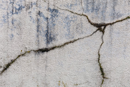 Huge cracks in the concrete foundation of the house. Abstract full frame textured backgroundの写真素材