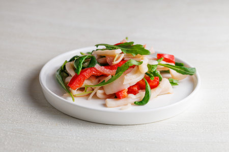 salad with squid, sweet bell pepper and arugula, with dressing, homemade, no people, Healthy eating conceptの写真素材