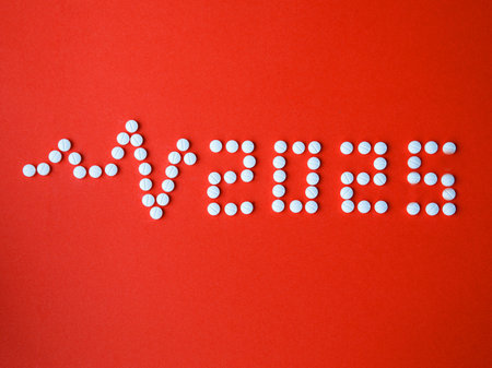 2025 Happy New Year banner for health care and medical concept. Number 2025 and cardiogram made from tablets on red background. View from above flat lay top view Medical concept.の写真素材