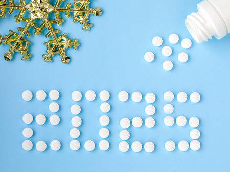 2025 Happy New Year banner for health care and medical concept. Number 2025 made from tablets, tablets blow out or ejection from bottle on blue background. View from above flat lay. Medical conceptの写真素材