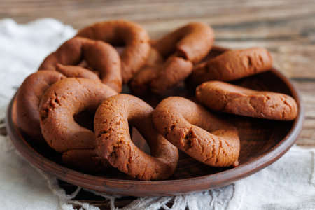Traditional cretan pekmezi cookies moustou koulouri on clay plate and white napkin close upの写真素材