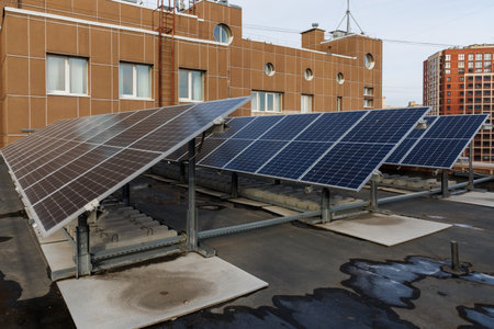 solar power plant on a roof of modern public building in big city at cloud day to generate green...