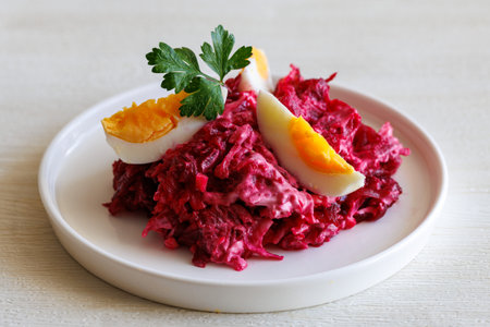 Beetroot salad with mayonnaise with cheese and egg on white background close upの写真素材