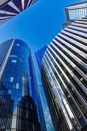 skyscraper buildings in business district, London City. Blue sunny day sky. Low angle view. Europe financial economy, merger and acquisition, or modern architecture concept, verticalの写真素材