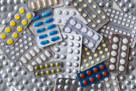 Colorful medical drugs and pills in silver shiny package full frame background. Top view. Medicine and healthcare conceptの写真素材