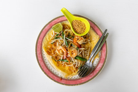 Stir fried rice noodle thai style with shrimps and vegetables Pad Thai kung sod on omelet on white background, food popular with Thai and foreigners. Have a delicious national taste good. Top viewの写真素材
