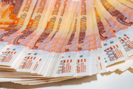 Many five-thousand-rubles bills lie in a fan. Banknotes of 5000 rubles. The Russian national...