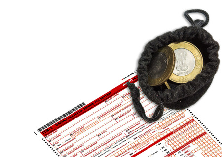 Tax Form ITR-1 with Indian coins put inside the bagの写真素材