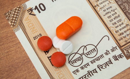 Concept of the affordable medicine in India due to generic drugs on Indian currency notes as background.の写真素材