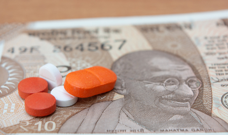Concept of the affordable medicine in India due to generic drugs on Indian currency notes as background.の写真素材