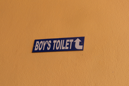 Direction showing of Boys Toilet on wall at collegeの写真素材