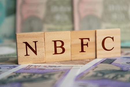 NBFC in wooden block letters on indian currencyの写真素材