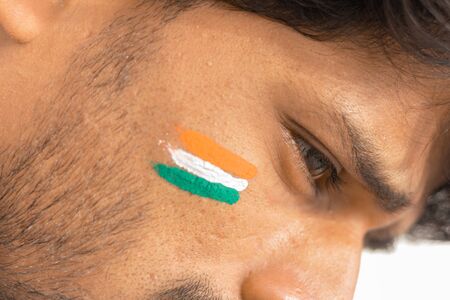 Closeup of a Tricolor Indian flag Painted on face to cheer India in cricket sportsの写真素材