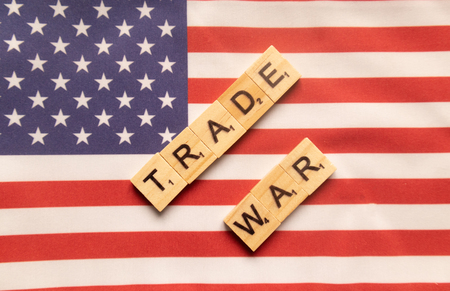 Maski, India 29,May 2019 : China-US trade war concept - flag of the United States with wooden block letters.のeditorial素材