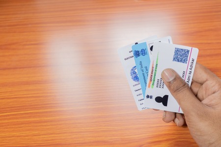 Maski,Karnataka,India -June 26 ,2019: Holding Aadhaar card, Ration card and voter ID which is issued by Government of India as an identity cardのeditorial素材