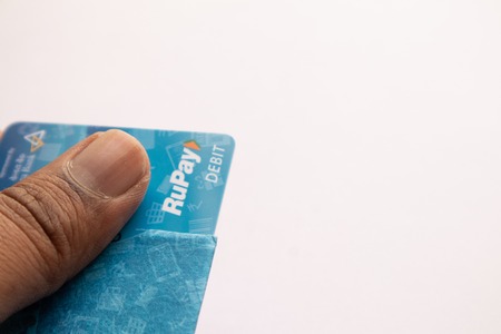 Maski, India - June 18, 2019 : Closeup of hands holding the RUPAY debit cards on Isolated backgroundのeditorial素材