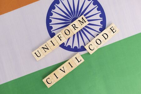 Concept of One law for all called Uniform Civil code or UCC in Indian constitution in wooden block...