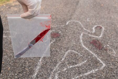 concept of crime scene investigation, Detective or investigator holding evidence bag with bloody...