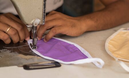 Home made diy protective mask against virus during mask shortage - Using sewing machine to sew the...
