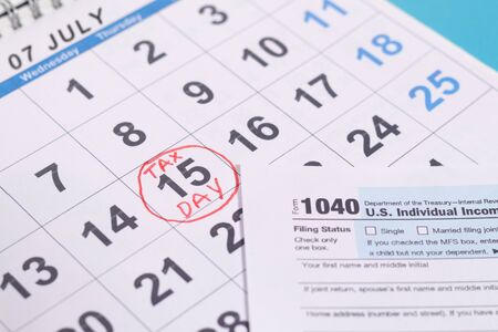 July 15th marked as tax day on calendar with Tax from - Concept of file tax form before deadline july 15thの写真素材