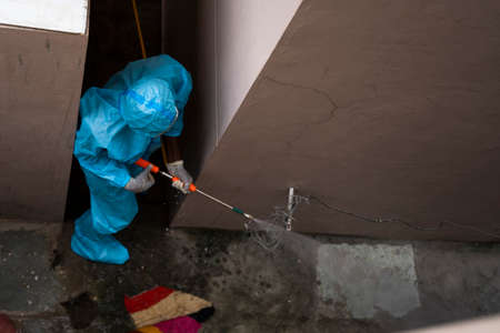 Frontline worker sanitizing or Disinfecting galli, alley or alleyway due to covid-19 or coronavirus...